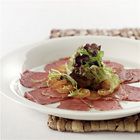 Carpaccio van wildzwijnfilet en kumquat