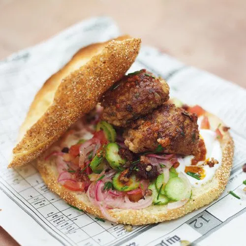 Köfte sandwich met salade van tomaat en komkommer