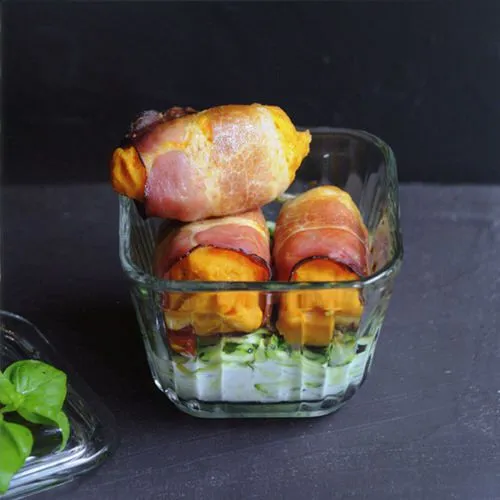 Tomatenquenelles in gerookte ham met gegratineerde courgette