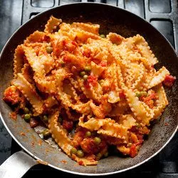 Tip: Reginette met langoustines, doperwten en tomaat